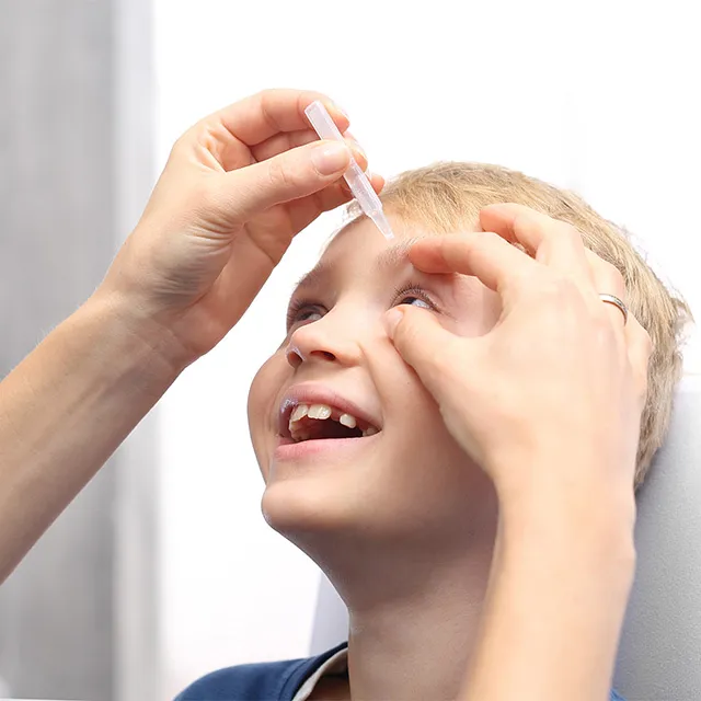 boy getting eye drops